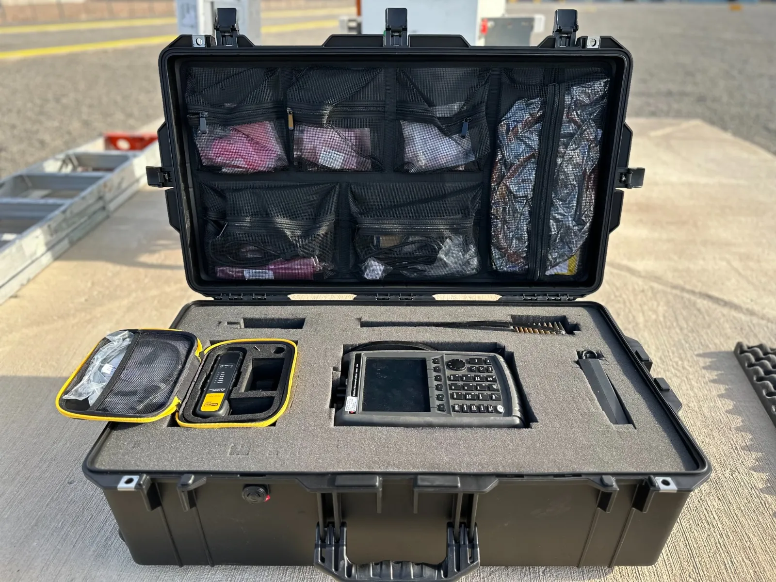 Rugged field case holding a handheld spectrum analyzer and RF test accessories
